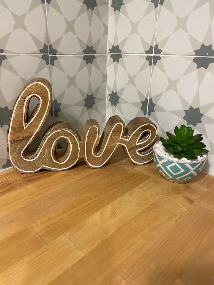 Wooden 'love' sign on butcher-block counter